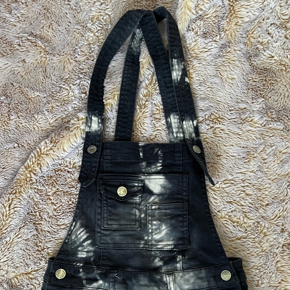Small child’s overalls with criss-cross straps and pockets